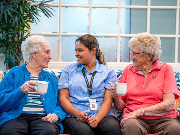 BAPTCARE AMBERLEA Residents and staff member sharing a story with tea