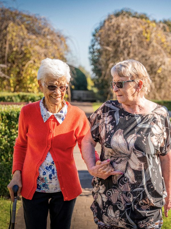 BAPTCARE AMBERLEA Residents who are also close friends go for a walk in the large courtyard gardens