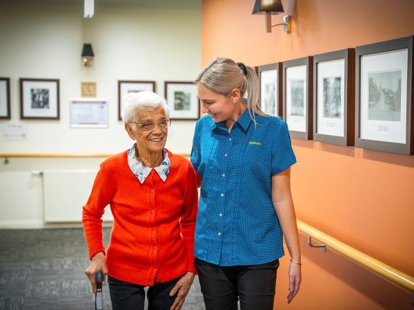 BAPTCARE AMBERLEA Residents and staff member going for a walk and chatting inside