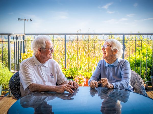 BAPTCARE AMBERLEA Resident friends chatting outside on the balcony