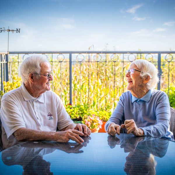 BAPTCARE AMBERLEA Resident friends chatting outside on the balcony