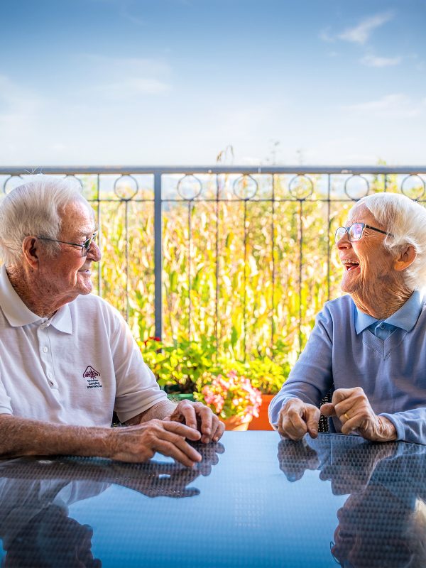 BAPTCARE AMBERLEA Resident friends chatting outside on the balcony