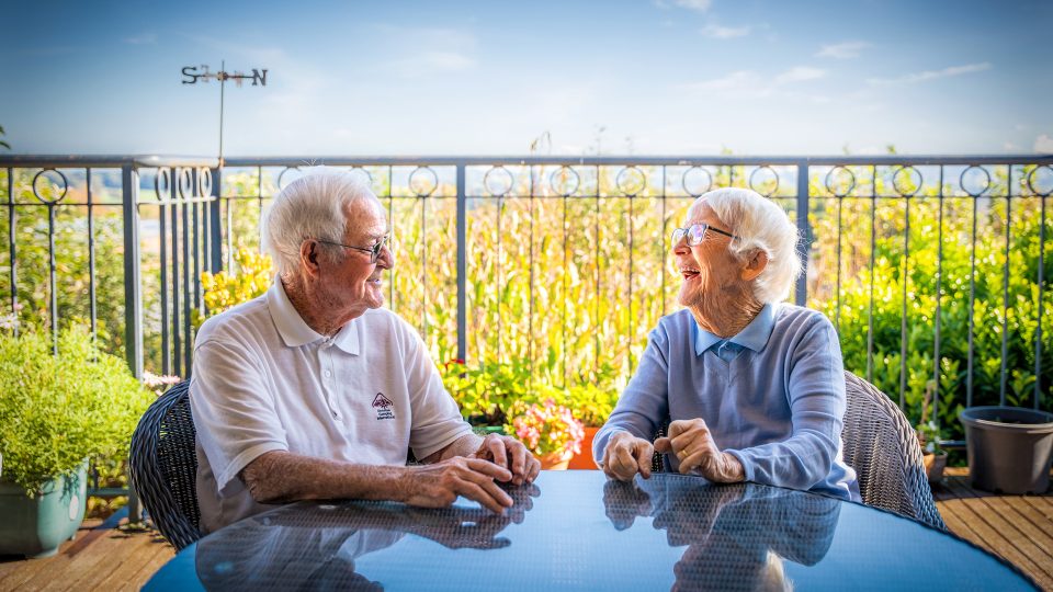 BAPTCARE AMBERLEA Resident friends chatting outside on the balcony