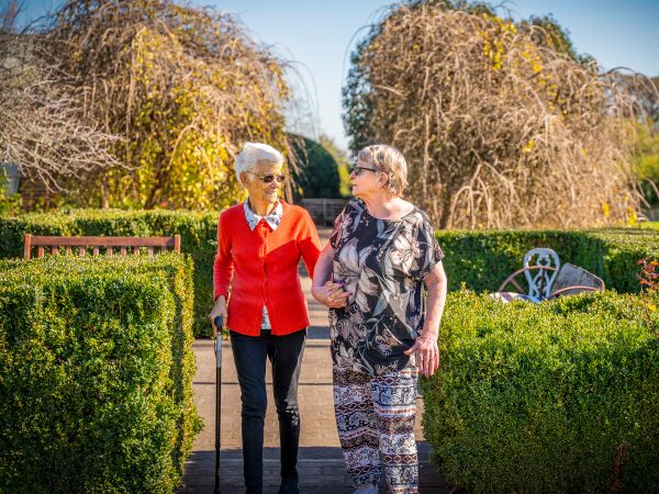 BAPTCARE AMBERLEA Residents who are also close friends go for a walk in the large courtyard gardens