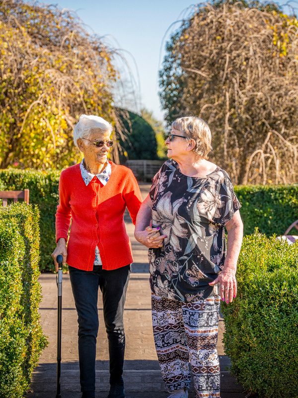 BAPTCARE AMBERLEA Residents who are also close friends go for a walk in the large courtyard gardens