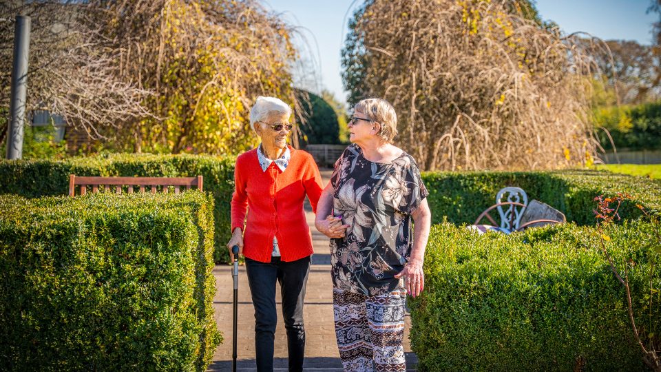 BAPTCARE AMBERLEA Residents who are also close friends go for a walk in the large courtyard gardens