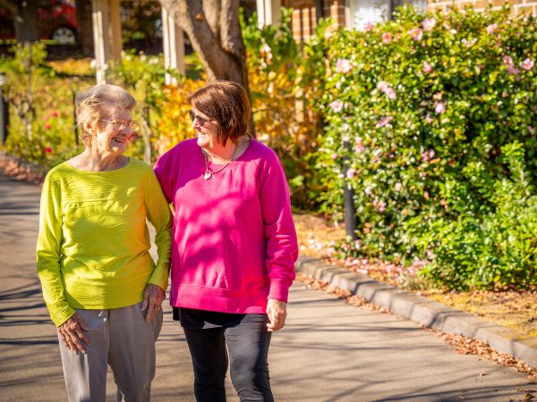 BAPTCARE AMBERLEA Resident and her daughter sharing a story as they walk in the gardens around the facility