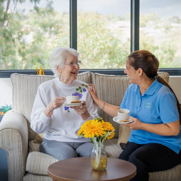 BAPTCARE BROOKVIEW Resident with staff member in the winter garden
