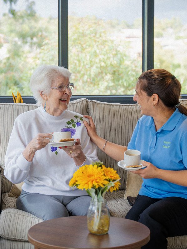 BAPTCARE BROOKVIEW Resident with staff member in the winter garden