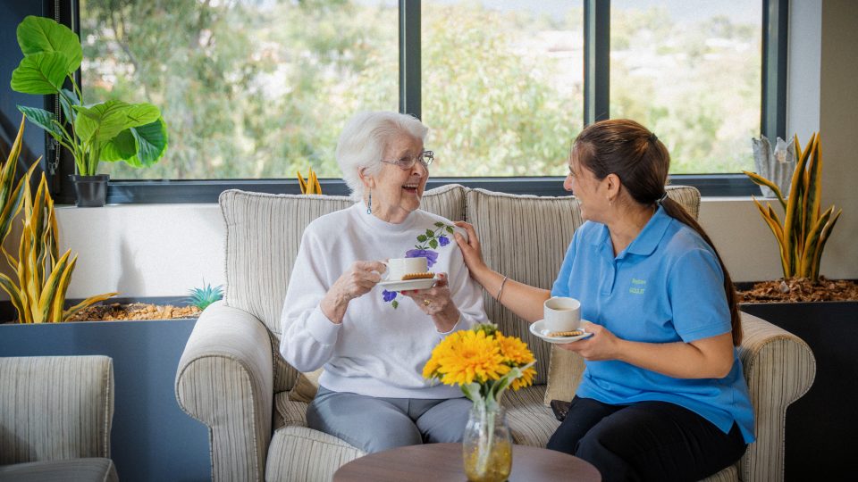 BAPTCARE BROOKVIEW Resident with staff member in the winter garden