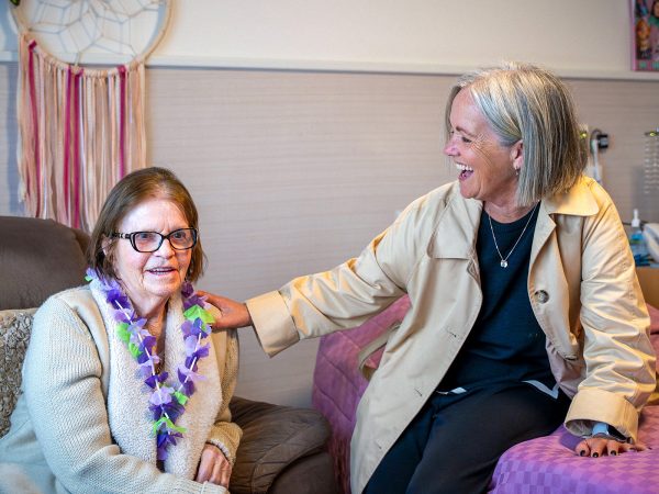 BAPTCARE COASTHAVEN Resident in her room with her daughter having a laugh