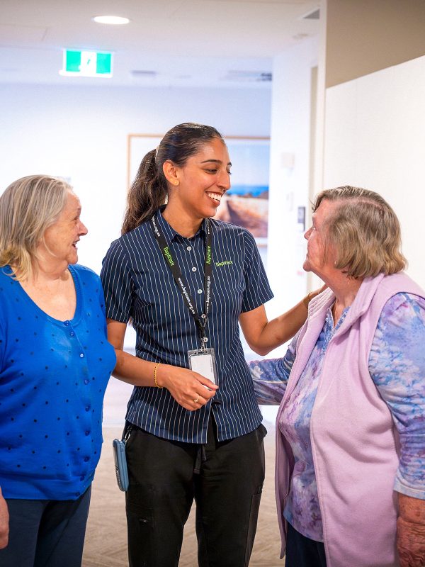 BAPTCARE COASTHAVEN Residents joking with a staff member near the Nurses station