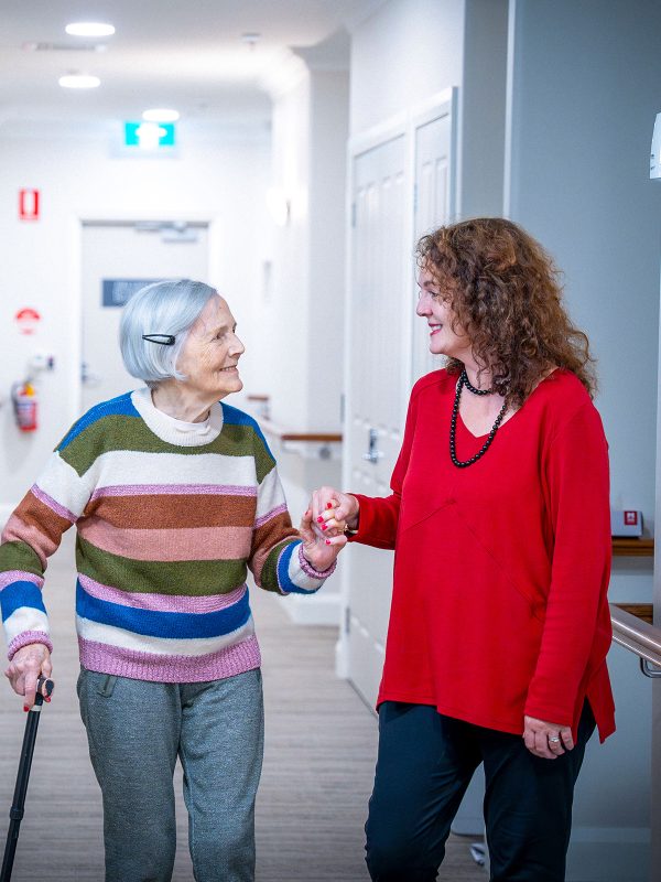 BAPTCARE HEDLEY SUTTON Resident mother and her daughter having an in depth conversation as they walk in the corridor