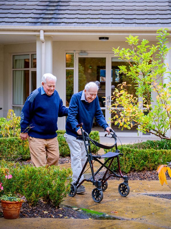 BAPTCARE HEDLEY SUTTON Resident long term friends chatting and taking a walk together in the courtyard garden