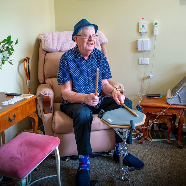 BAPTCARE HERITAGE MANOR Resident musician playing drums in his room