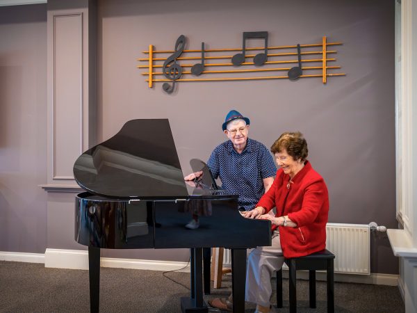 BAPTCARE HERITAGE MANOR Resident friends and musicians at the grand piano in the lounge area