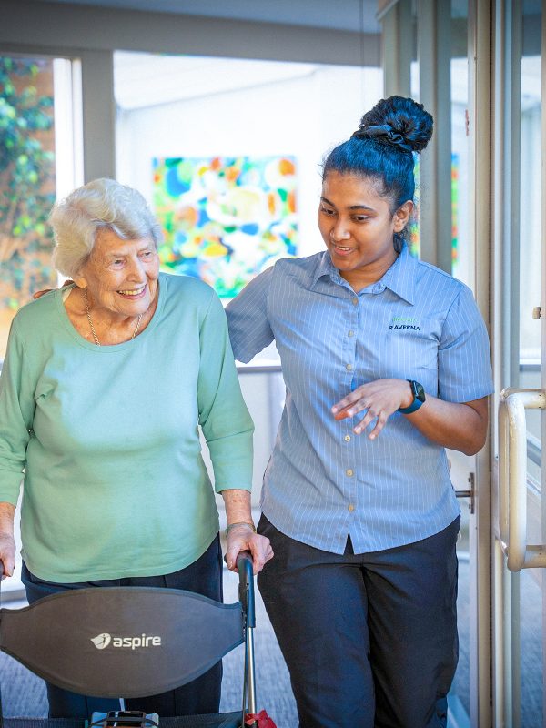 BAPTCARE KARANA Resident with staff member in chatting in common area