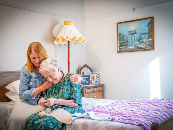 BAPTCARE KARANA Resident mother with daughter in room knitting conversation