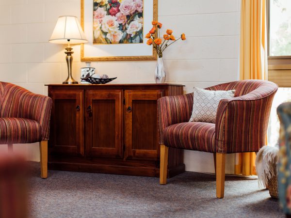 BAPTCARE NORTHAVEN lounge area with flowers and sideboard cupboard