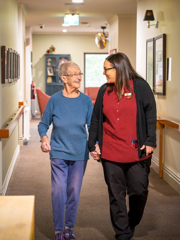 BAPTCARE PENINSULA VIEW resident and staff member taking a walk in the corridor