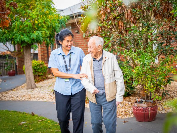 BAPTCARE ST HILARYS Residential Care resident and staff member outside enjoying the garden