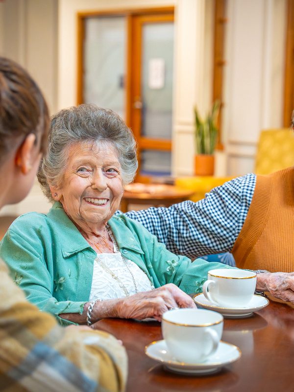 BAPTCARE ST HILARYS Residential Care resident and her daughters enjoying tea