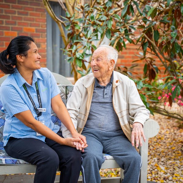 BAPTCARE ST HILARYS Residential Care resident and staff member outside enjoying the garden and a chat