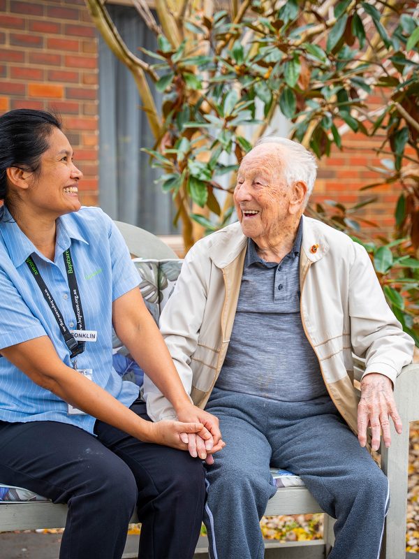 BAPTCARE ST HILARYS Residential Care resident and staff member outside enjoying the garden and a chat