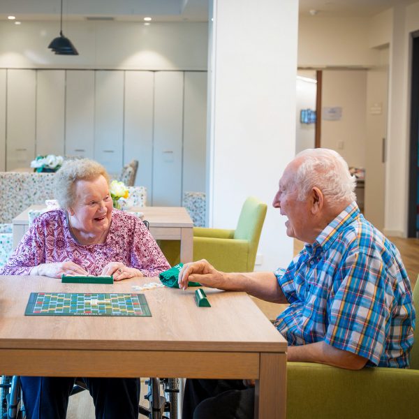 BAPTCARE WATTLE GROVE two residents in conversation over scrabble