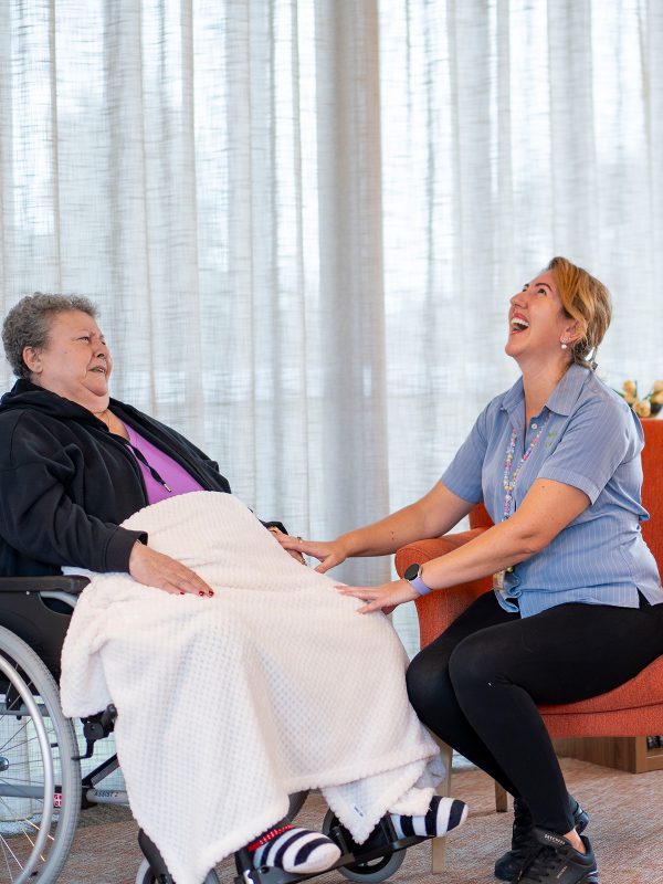 BAPTCARE WATTLE GROVE staff member and resident sharing a hearty laugh