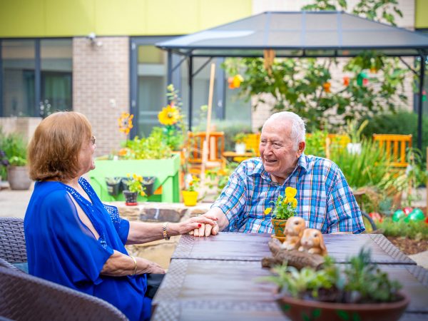 BAPTCARE WATTLE GROVE resident with his daughter in his outdoor area intimate conversation