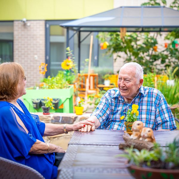 BAPTCARE WATTLE GROVE resident with his daughter in his outdoor area intimate conversation