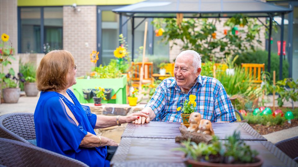 BAPTCARE WATTLE GROVE resident with his daughter in his outdoor area intimate conversation