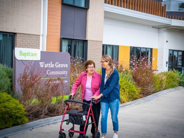 BAPTCARE WATTLE GROVE Resident mother and daughter at the front entrance walking and chatting