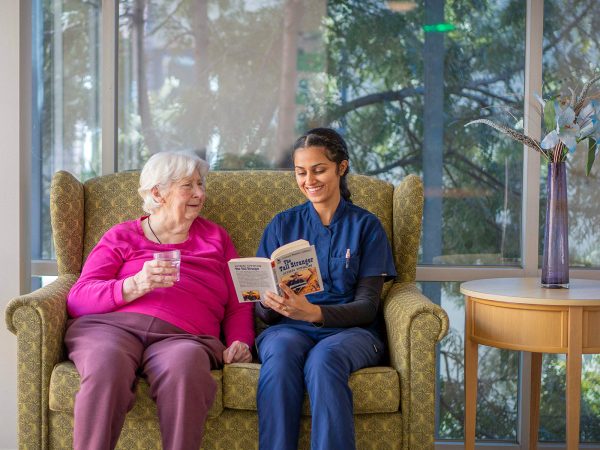 BAPTCARE WESTHAVEN resident and staff member reading together