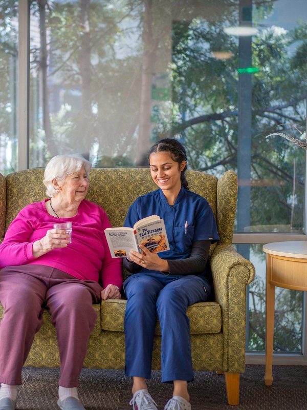 BAPTCARE WESTHAVEN resident and staff member reading together