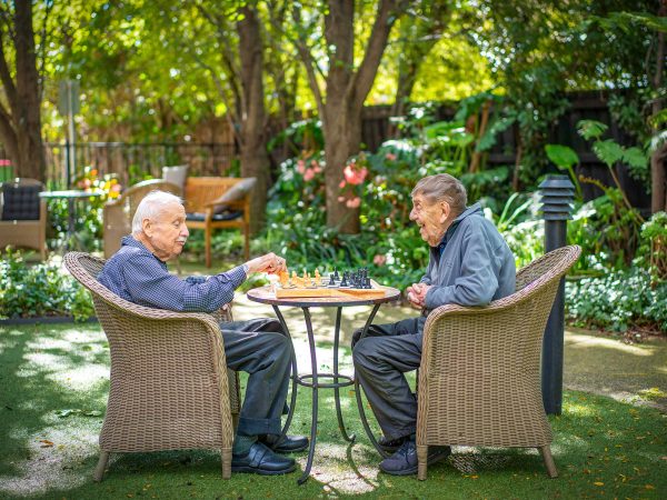 BAPTCARE WESTHAVEN two resident friends playing chess outside in the garden