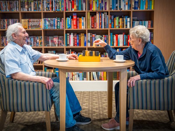 BAPTCARE Wyndham Lodge two resident friends at play a board game in the library