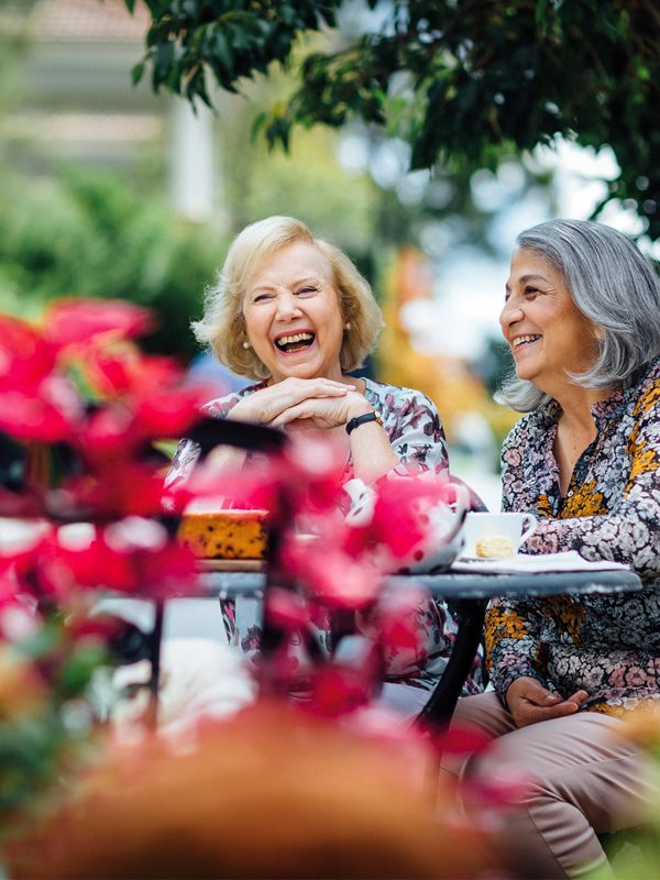 Residents outside their Baptcare Strathalan Retirement Living villa enjoying a laugh