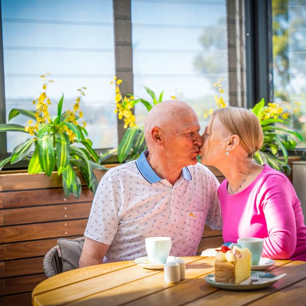Residents at members lounge at Baptcare Strathalan Retirement Living community hub in outdoor area