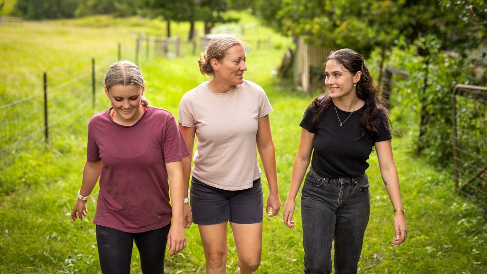 KINSHIP CARE two teenage girls going for a walk with their young auntie who now looks after them in the country