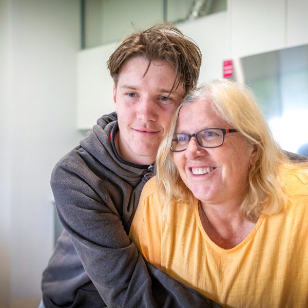 KINSHIP CARE Anglo auntie getting a hug of thanks from her teenage nephew