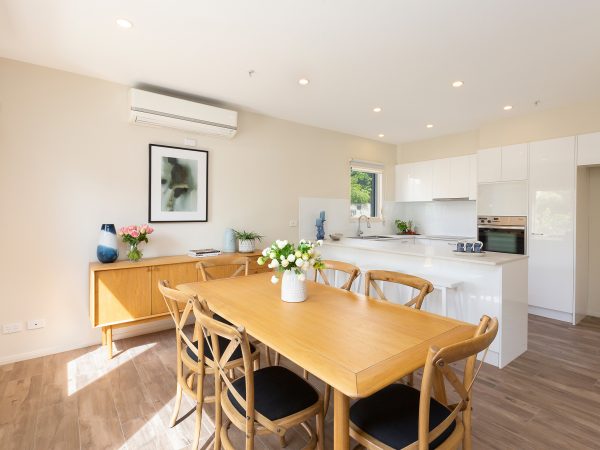 View of dining area and kitchen in apartment at Karana Retirement Living