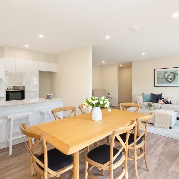 View of dining area and kitchen in apartment at Karana Retirement Living