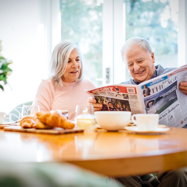 Enjoying the paper, laugh and breakfast at their apartment at Karana Retirement Living