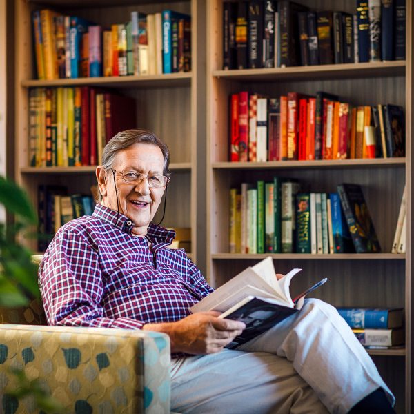 Enjoying a quiet read in his apartment at Karana Retirement Living