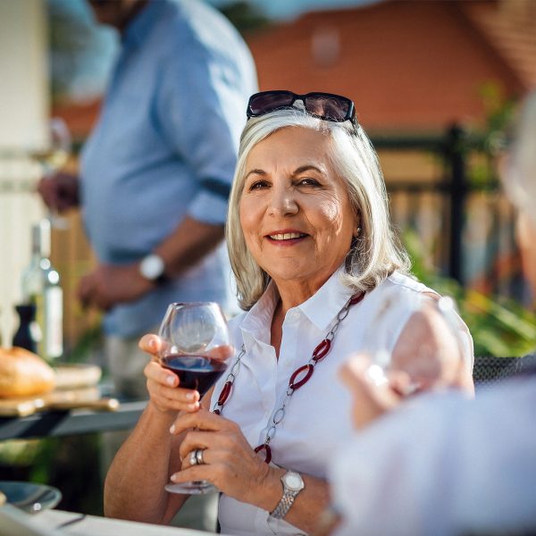 Enjoying a glass of wine on the balcony at Karana Retirement Living