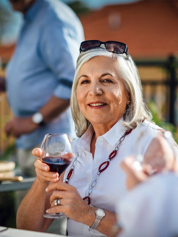 Enjoying a glass of wine on the balcony at Karana Retirement Living