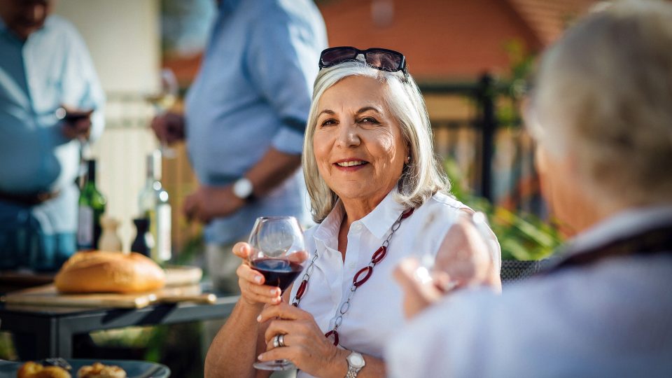 Enjoying a glass of wine on the balcony at Karana Retirement Living