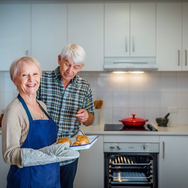 Resident inside her apartment at Westhaven with her partner cooking